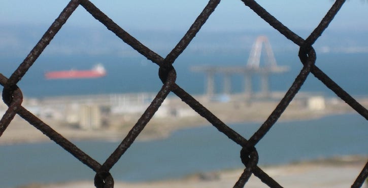 View of SF Bay and Hunter's Point through a chain fence