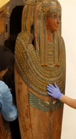 Two students moving sarcophagus